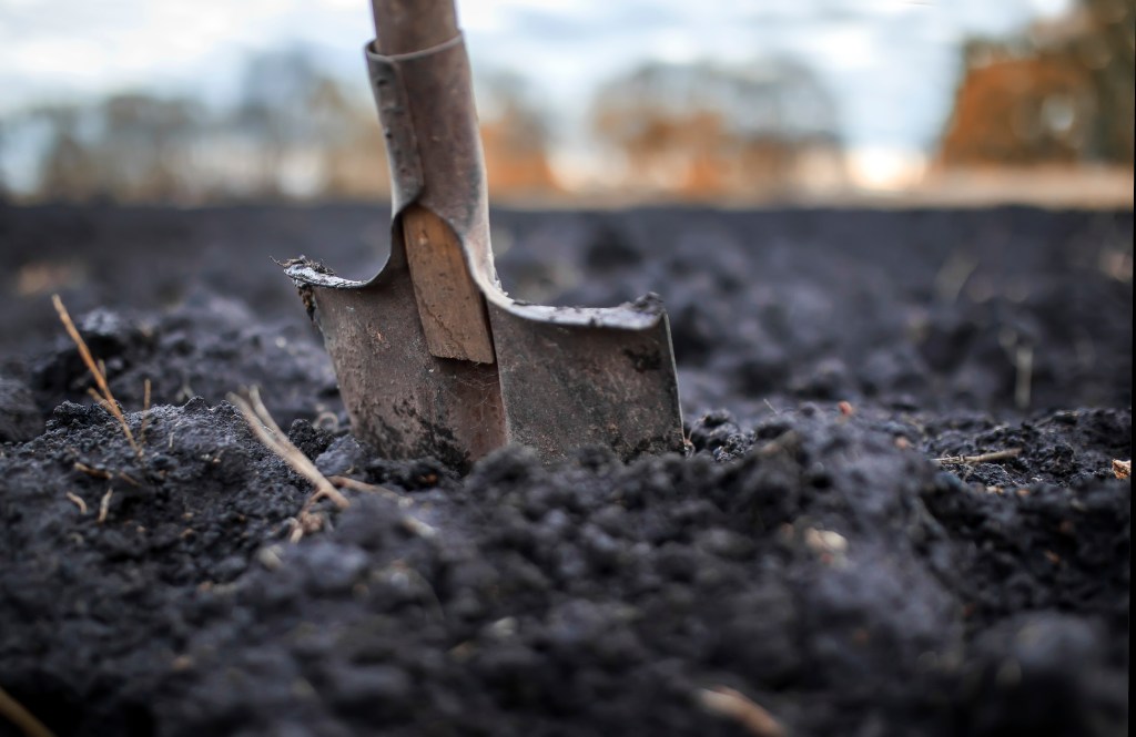 A shovel planted in soil