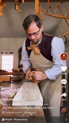 A screenshot of the Old Salem TikTok account of a person doing woodworking with the caption "Sanding in the 18th and early 19th century"