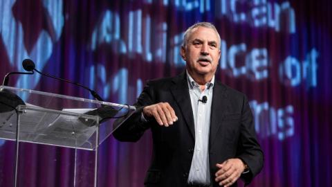 Thomas L. Friedman standing next to a podium and speaking