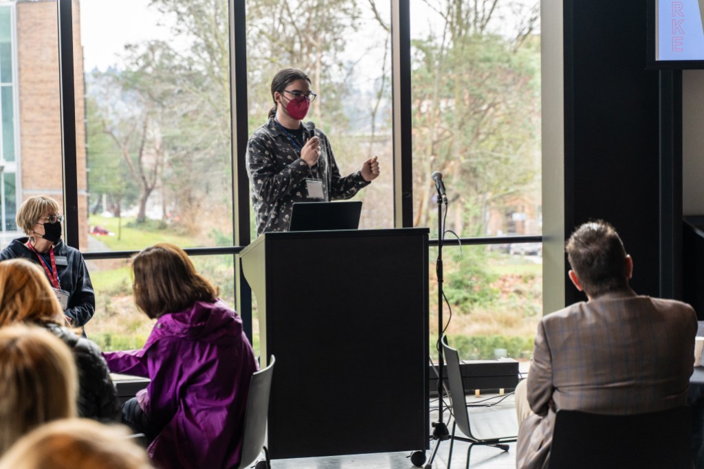 A person speaking behind a podium