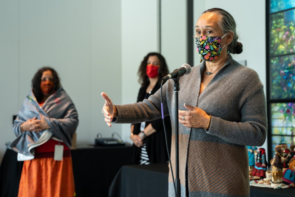 A person speaking behind a microphone