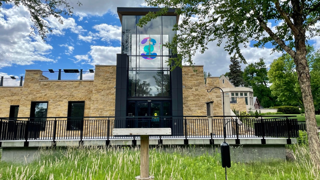 Exterior of a brick museum building with a glass entryway