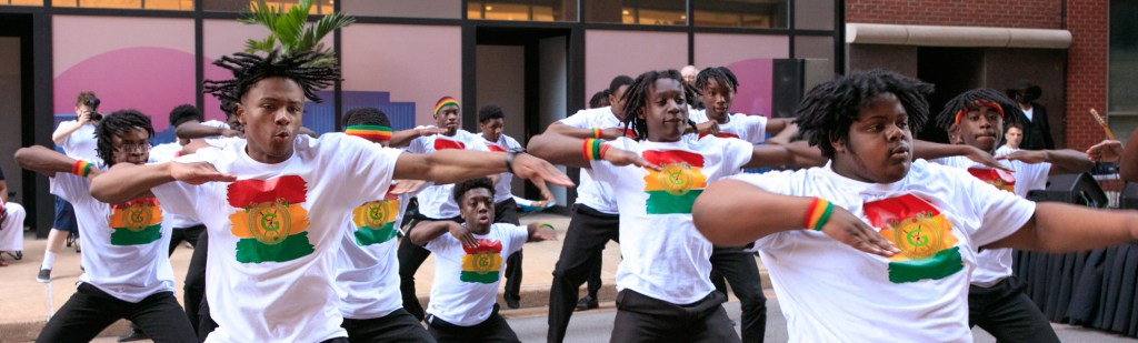 Dancers performing a choreographed routine in the street