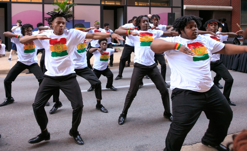 Dancers performing a choreographed routine in the street