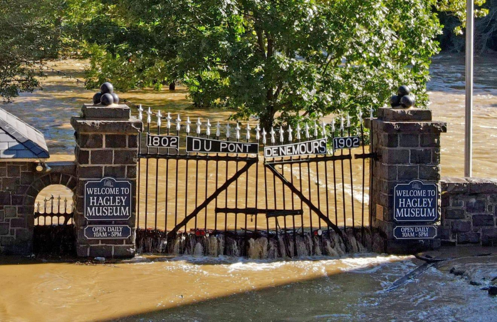 Entrance gate to the Hagley Museum with water flooding the driveway