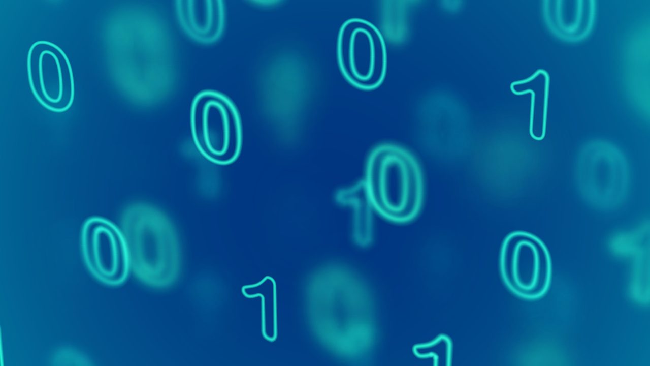 A graphic with zeroes and ones representing binary code floating in space