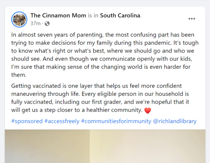 A sponsored Facebook post from The Cinnamon Mom with a caption about why everyone in her family got vaccinated with a photo of her reading to one of her children