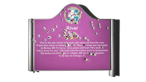 A commemorative plaque with bullet holes that says River with descriptive text.