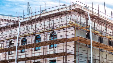 A historic building facade covered in scaffolding