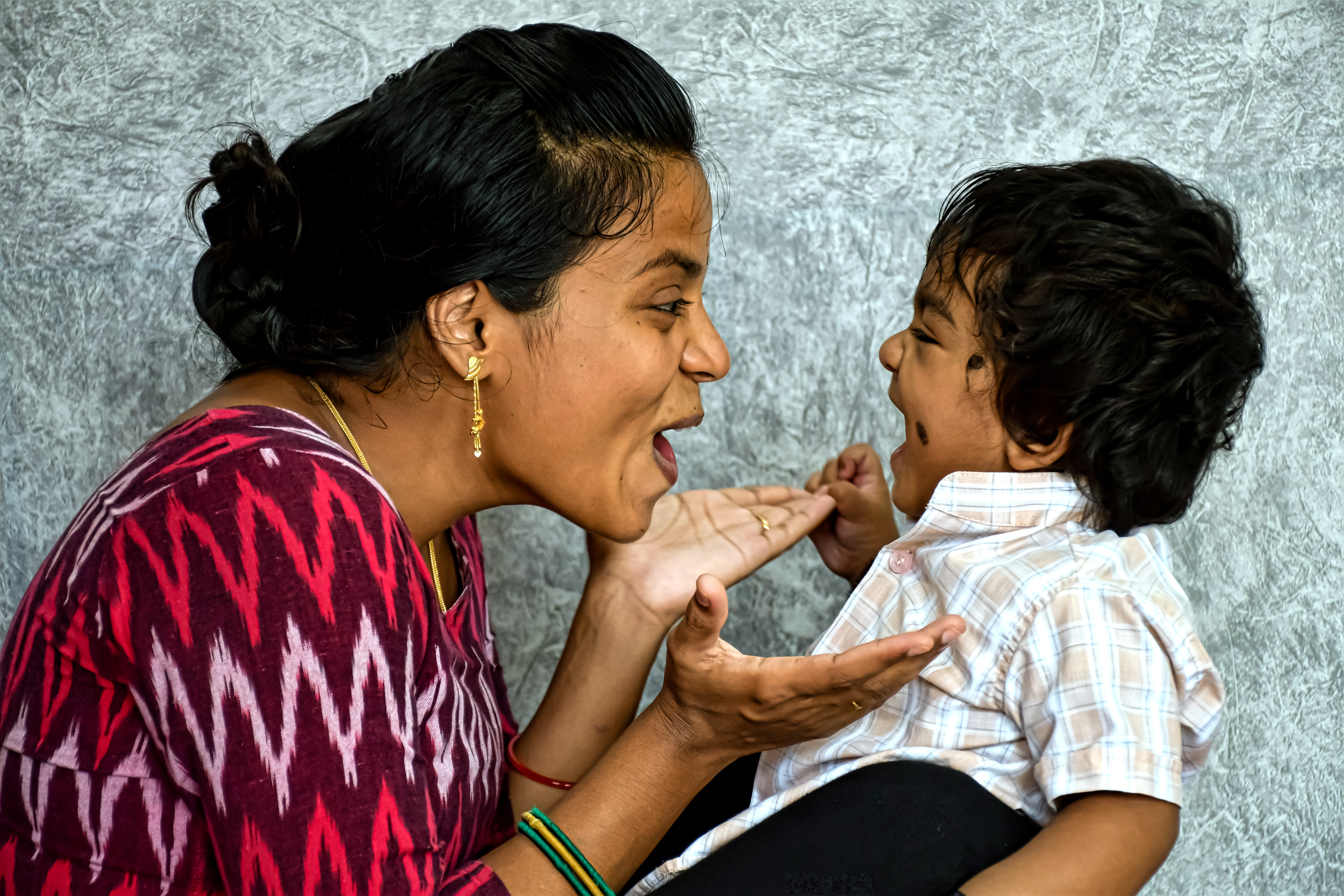 Photo of a child and adult laughing. Photograph by Saradhi Photography