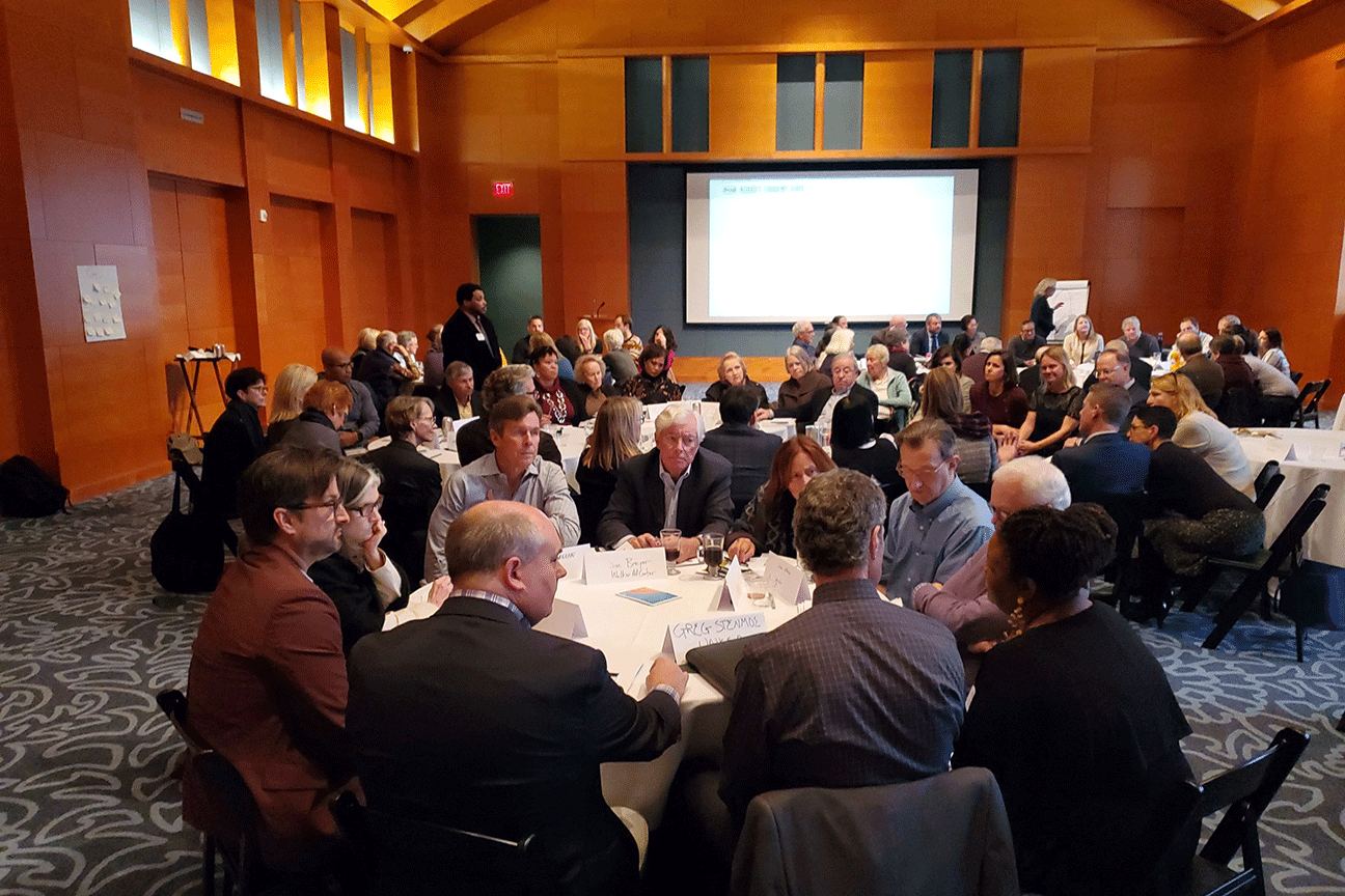 a photo of Facing Change participants seated at rounds during a training