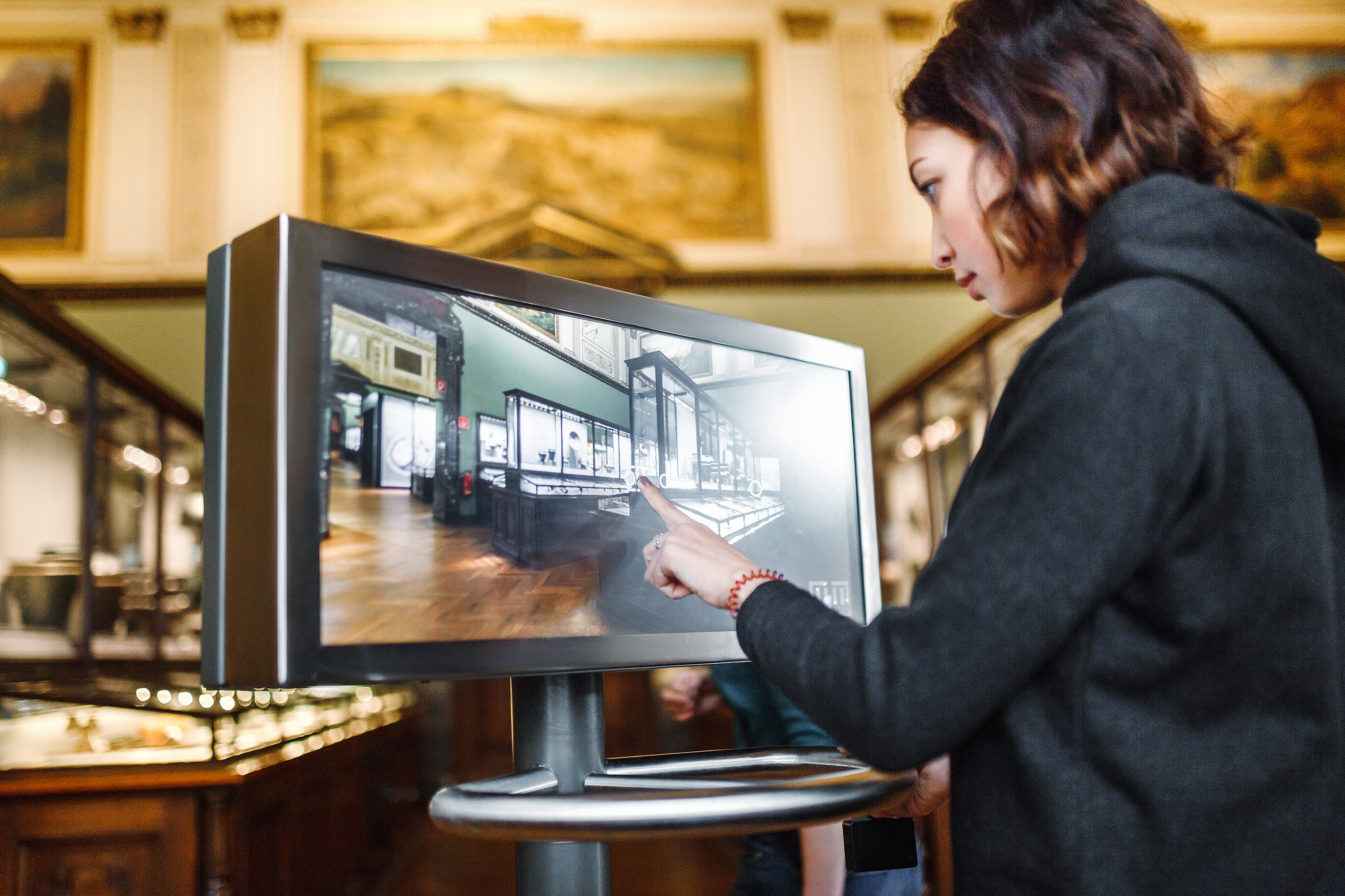 a person interacting with a digital display in a museum