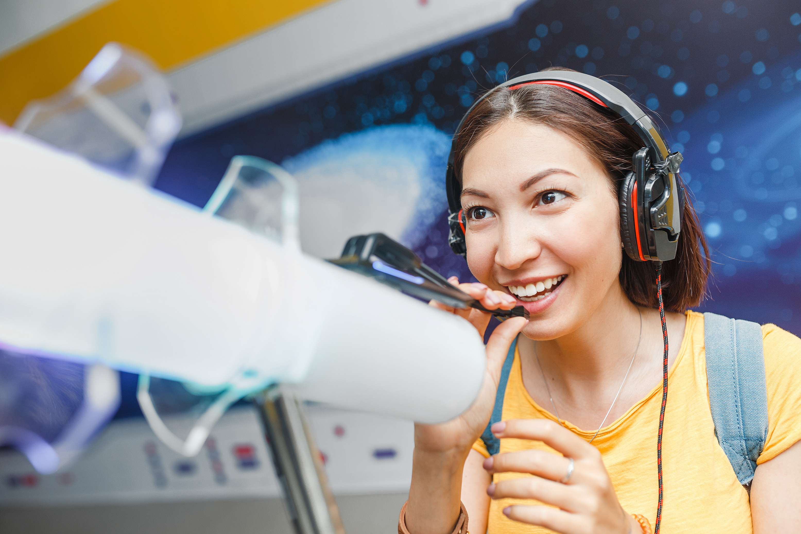 A person with headphones on engaging in an interactive exhibit