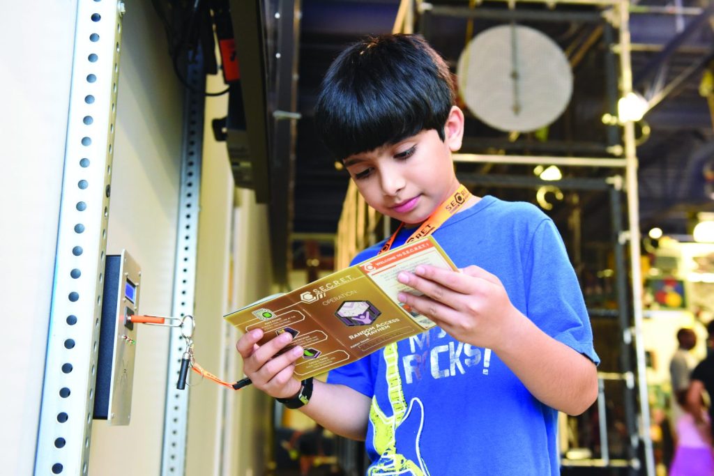 A young man reads a passport in the exhibit.