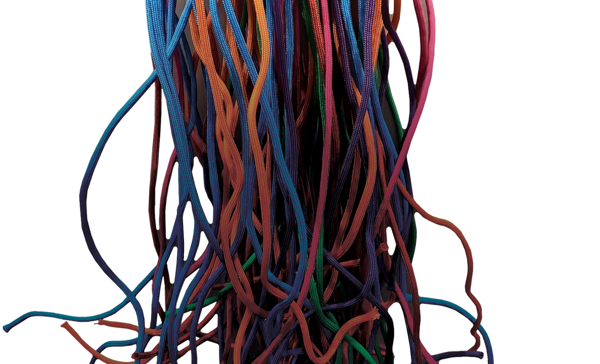 A bundle of different colored strings handing down and curling at the ends.