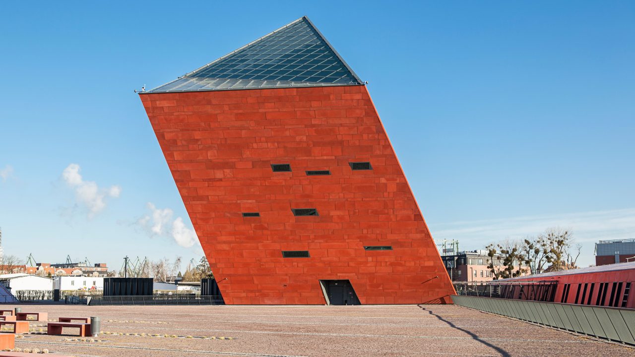 A red brick building with a leaning structure