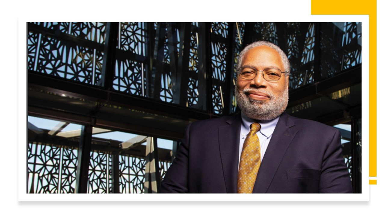 Lonnie Bunch, III stands in front of a window at the National Museum of African American History & Culture.