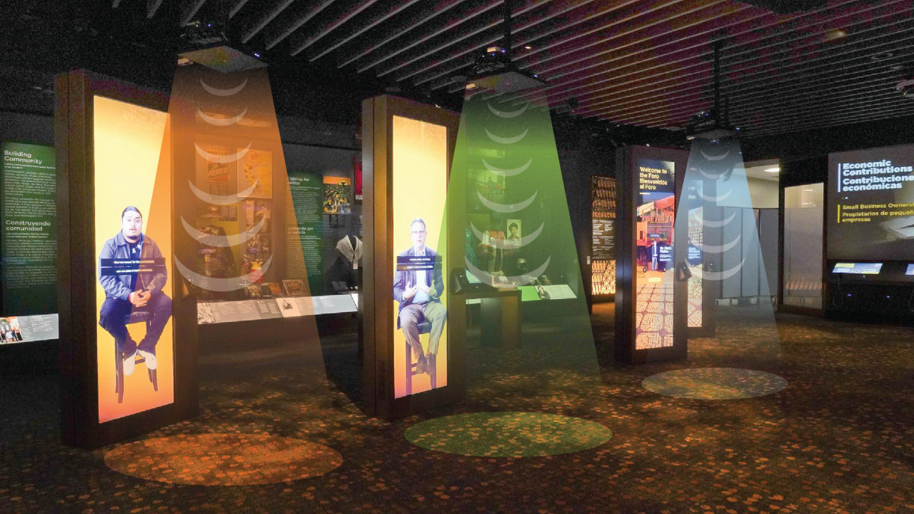 A screen panel display of three interview subjects with audio speakers above the screens and graphics of sound beams emanating from them
