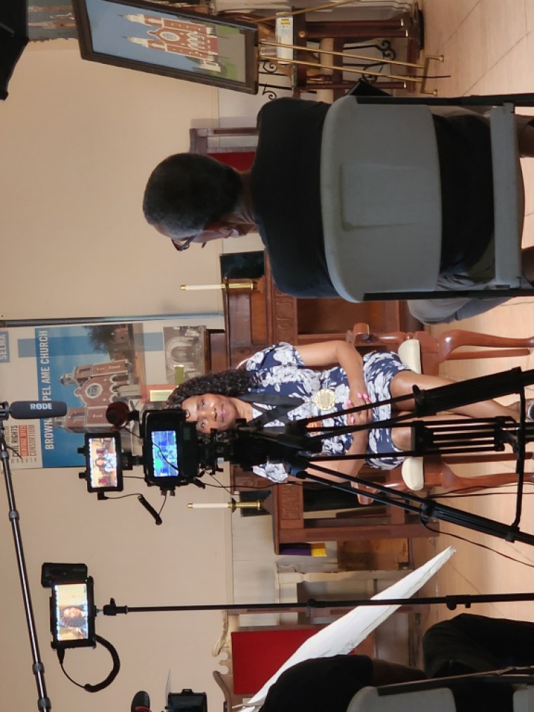 A subject speaking to a camera crew