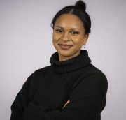 Female with dark hair, in black turtneck sweater