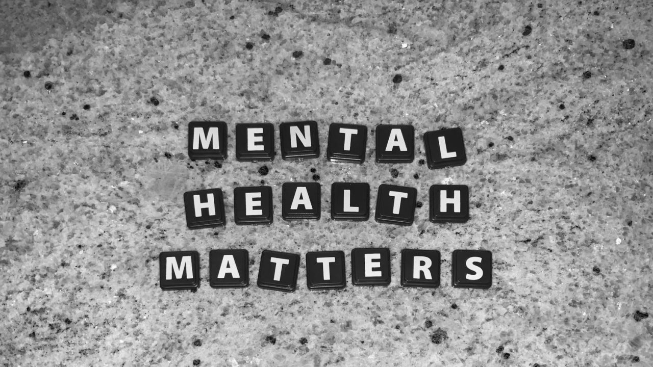 A granite counter with black Scrabble squares that spell Mental Health Matters
