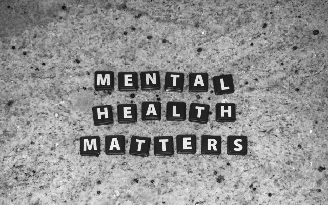 A granite counter with black Scrabble squares that spell Mental Health Matters