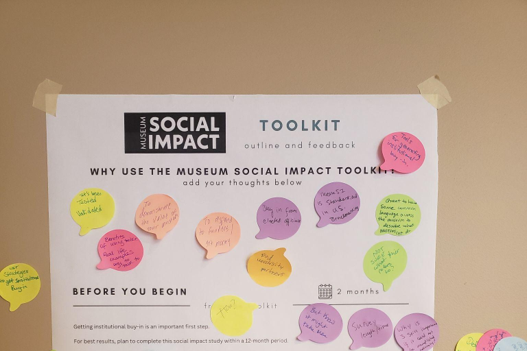 A posterboard asking people to give their responses to why they would use the Museum Social Impact Toolkit