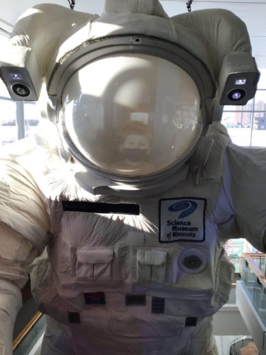 A space suit with the helmet shield down. 