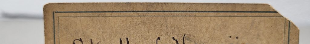 An antique label with the logo of Oberlin College and "Skull of Hawaiian, from Cave Burial Place. Hawaiian Ids. E.P. Church. Ac. 65" handwritten on it.