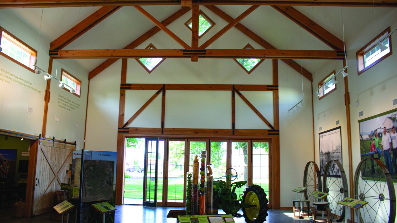 An open space inside a barn building with an exhibition on display.