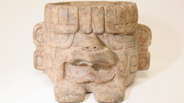 A stone sculpture resembling a human face