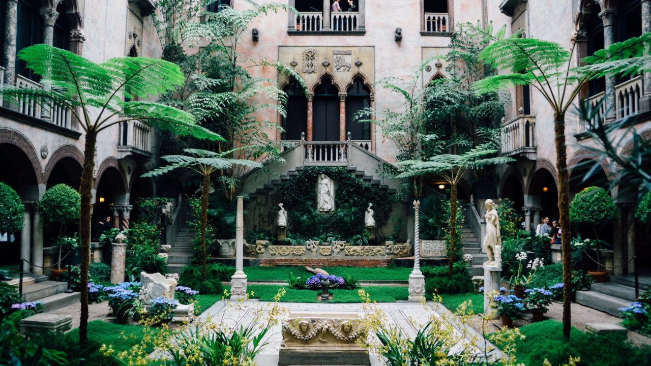 A courtyard space with sculptures and garden displays