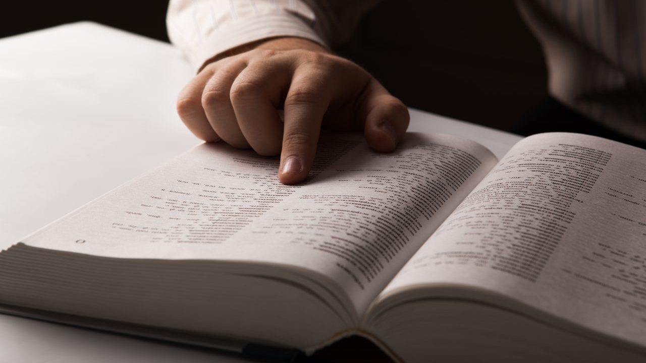 A person looking for information in a directory close-up