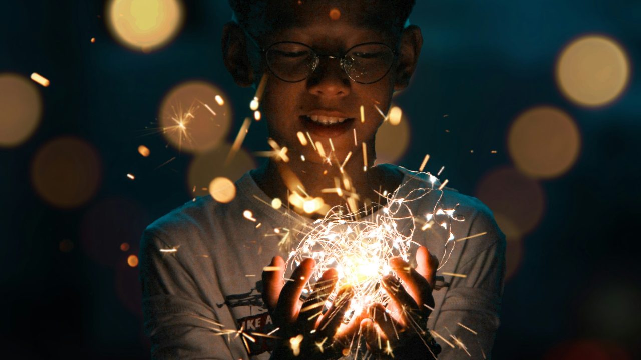 A child holding a tangle of fairy lights