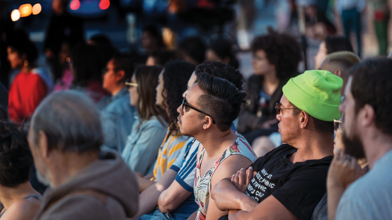 A group of people sitting and watching a performance