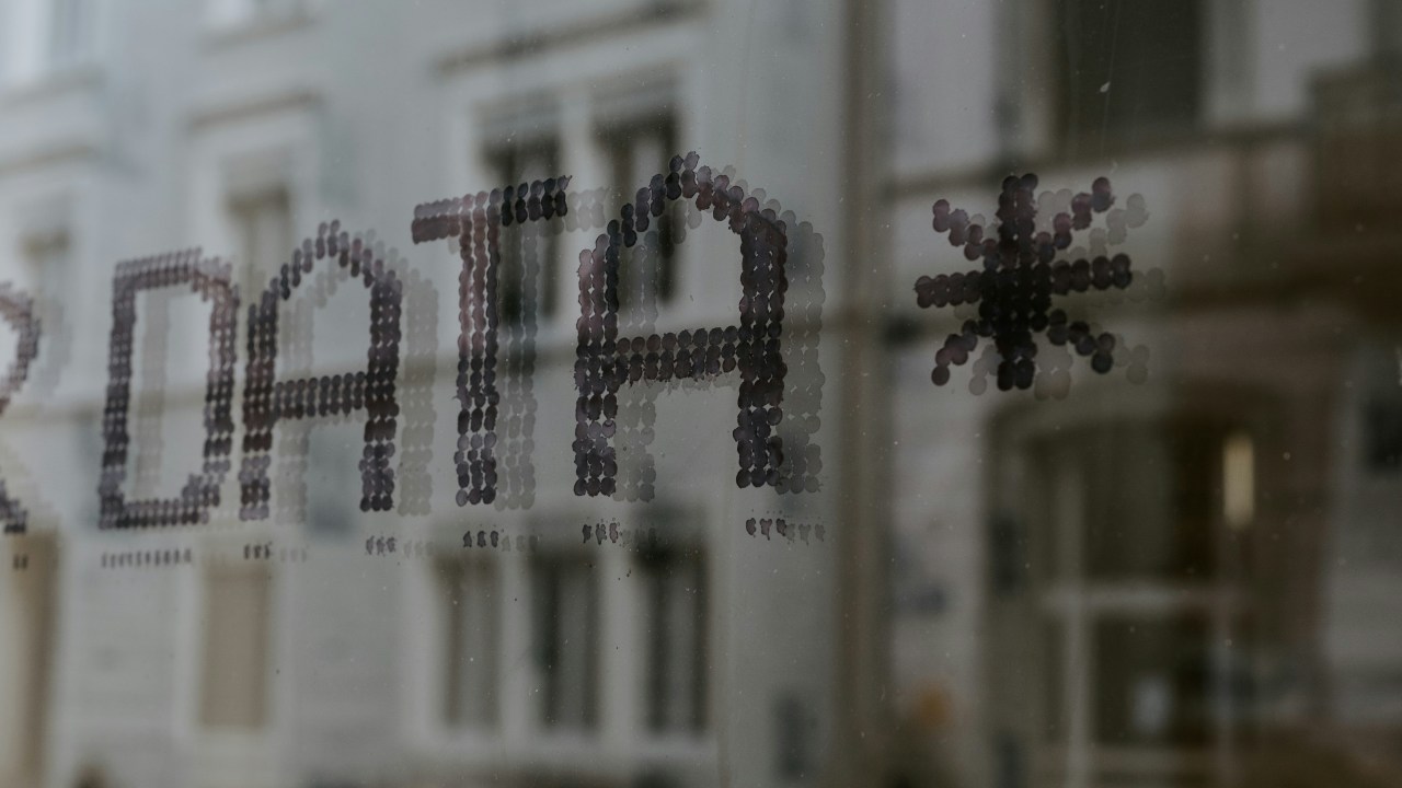 A glass facade with the word "data" projected on it