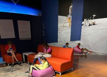 Children sit in beanbags in a sitting area at the museum. 