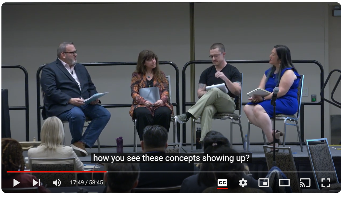 Screenshot of the Imprint Series: The Social Work of Museums video with four speakers on a dais with a crowd of tables and chairs in front.