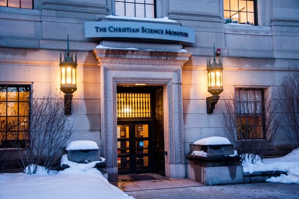 An exterior of an office building labeled with the name of the Christian Science Monitor