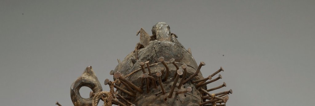 A power figurine from Kongo, Africa constructed with wood, natural fibers, glass, metal, and other materials.