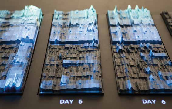 A group of 3D image pieces of plastic that are sitting on a table with numerous peaks and valleys. 