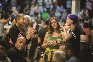 Visitors engage in a thoughtful conversation at the museum during the weekly Friday Nights at OMCA program.