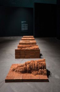 Interior view of an art installation showing erosion of different elements.