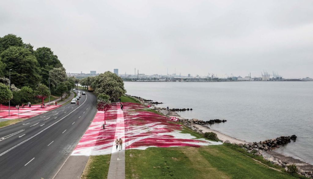 View of the exterior of the museum grounds with a road and the art installation crossing the road.