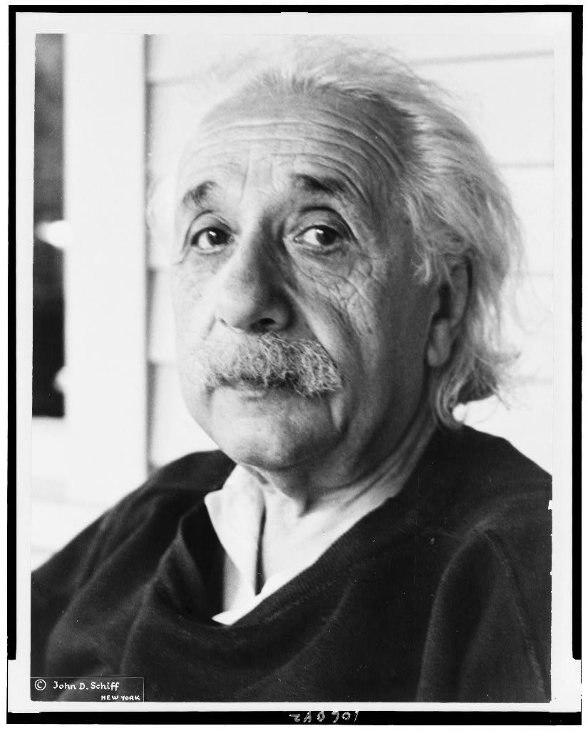 A black-and-white head-and-shoulders portrait of Albert Einstein in old age.