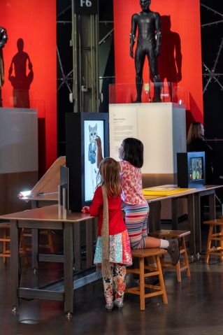 Two children interacting with a touch-screen installation in the Gender Blender exhibition.
