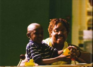 A mother and son play with rubber ducks in an exhibition. 