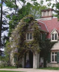 Exterior shot of a ivy covered Spanish colonial style home.