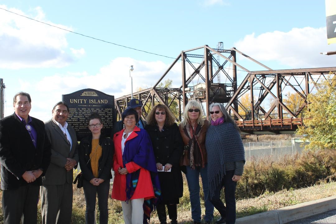 A group shot of people in front of the new historical marker reading "Unity Island."