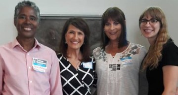Speakers at a CAMP meeting about museum inclusivity issues around gender identity are shown posing together.